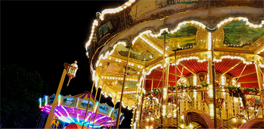 A colourful and brightly lit carrousel at night